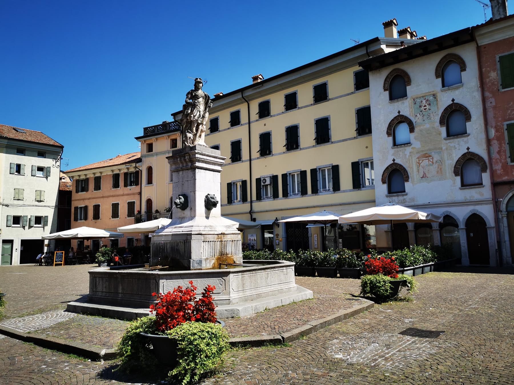 Fountain and painted facades on Piazza Paolo Diacono in Cividale del Friuli