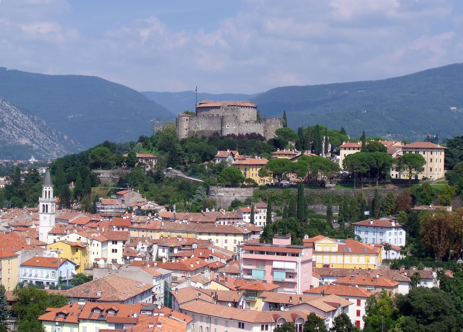 Gorizia's red rooftops below the castle hill and surrounding mountains