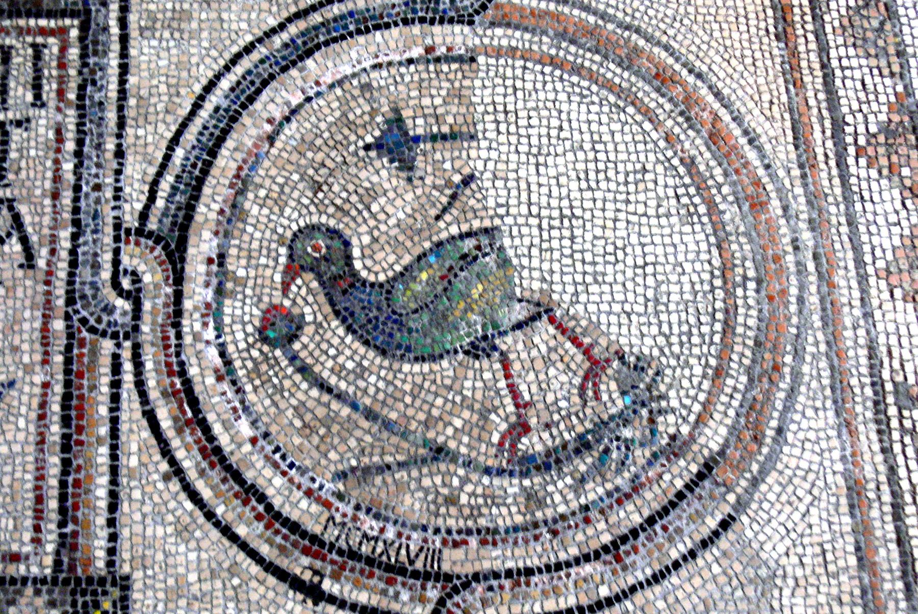 Colourful early Christian floor mosaic of a bird in a roundel