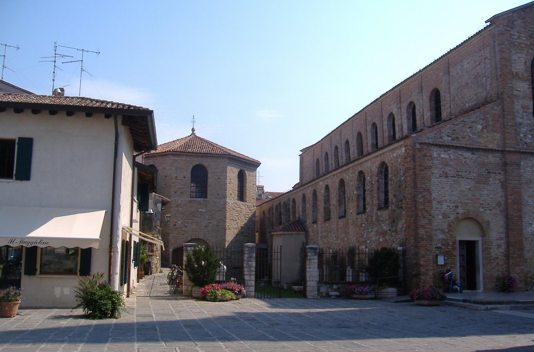 Octagonal early Christian baptistery beside the brick flank of Sant'Eufemia