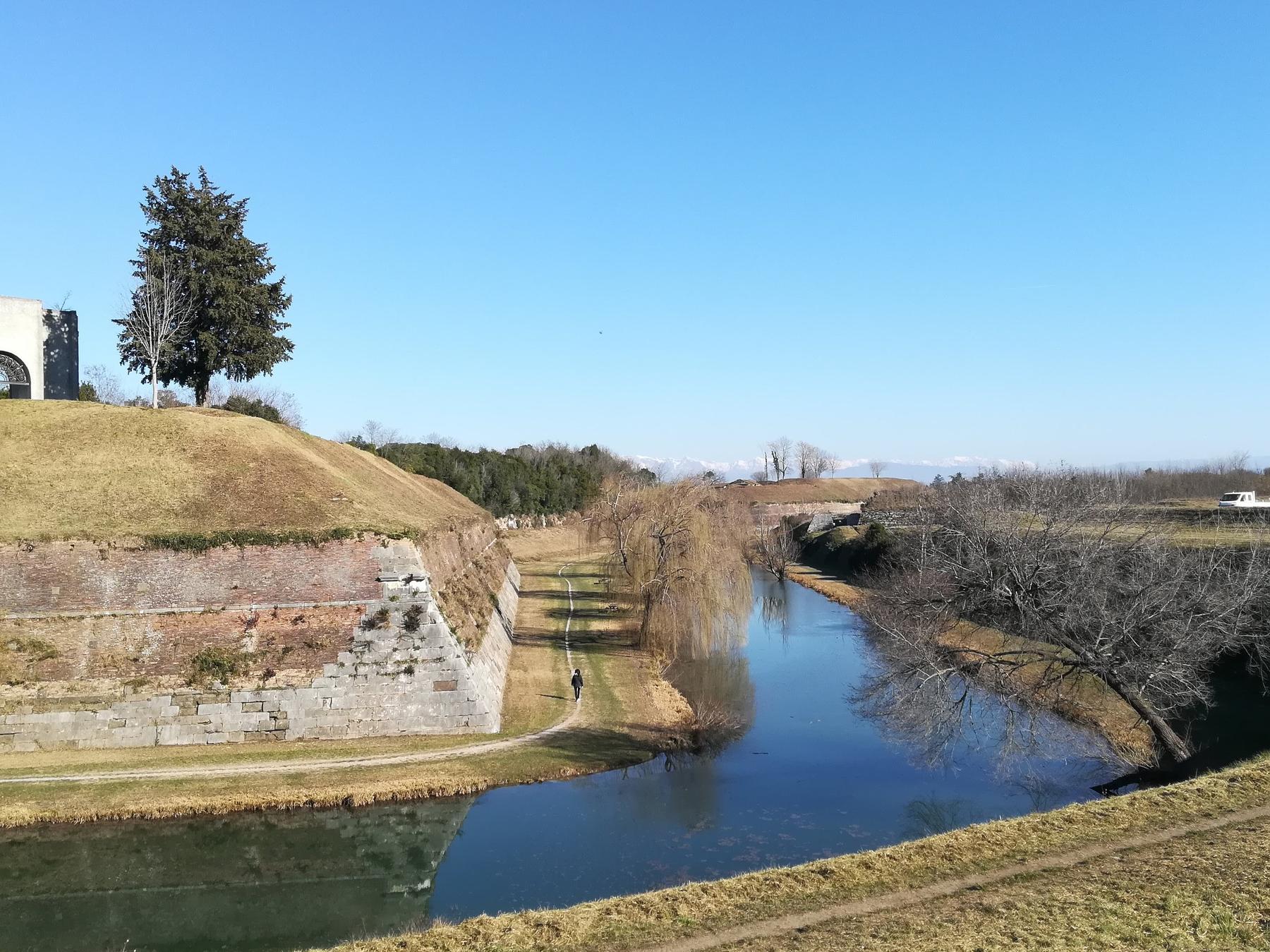 Grassy bastions and water-filled moat of Palmanova's star fortress
