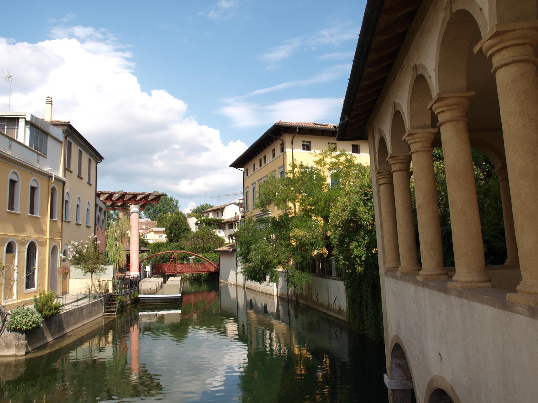 Branch of the Livenza beside a Renaissance loggia and riverside gardens in Sacile