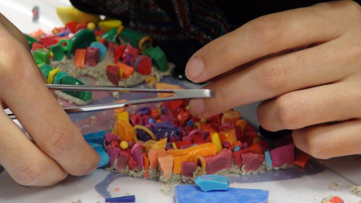 Setting small mosaic tiles with tweezers at the Scuola Mosaicisti del Friuli