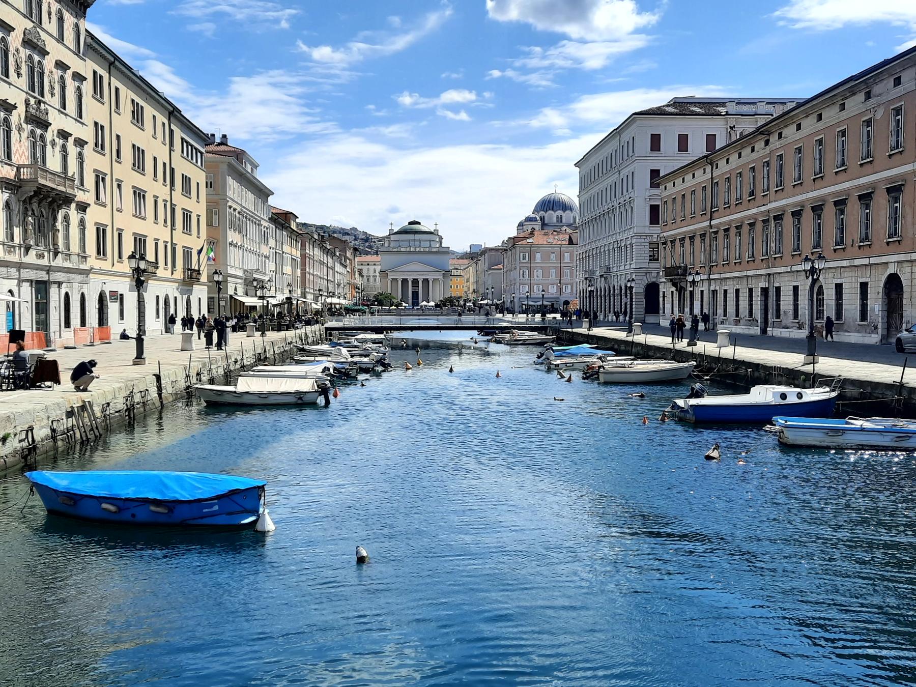Canal Grande in Trieste with moored boats and Sant'Antonio Taumaturgo church
