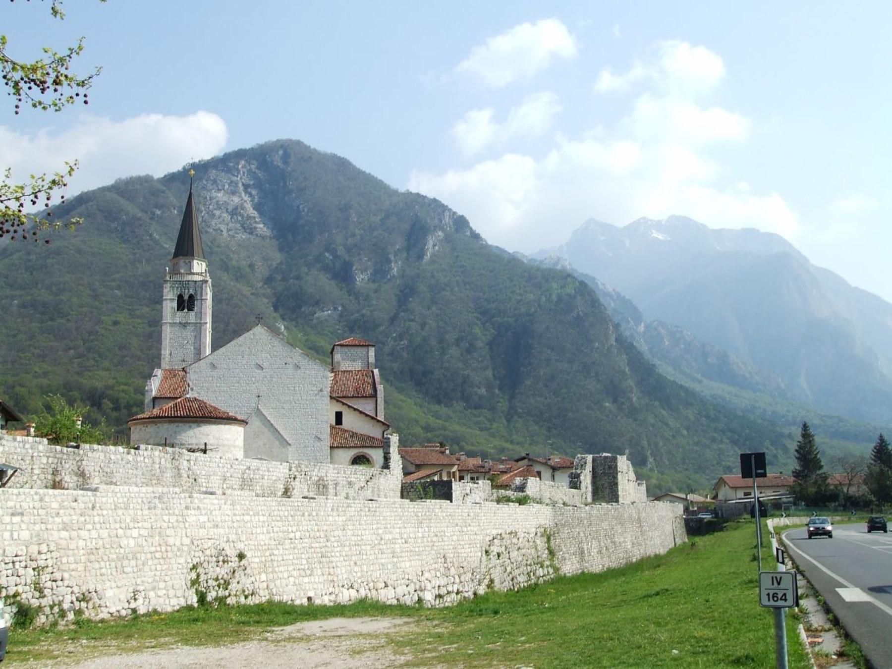 Venzone and its walls beneath the mountains